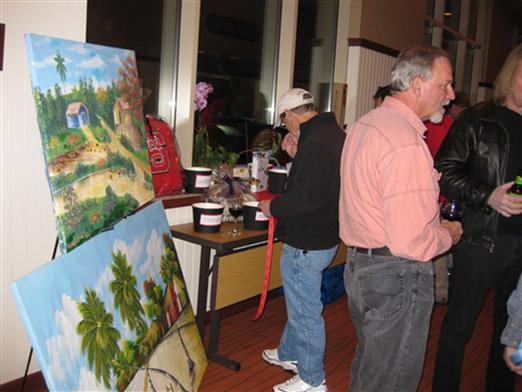 “Shopping” at the student raffle. I am the new proud owner of those paintings since Jim Rice was out of the country!