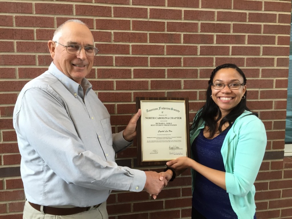 Dr. Rich Noble presents Crystal Lee Pow the 2015 Richard L. Noble Best Student Paper Award.