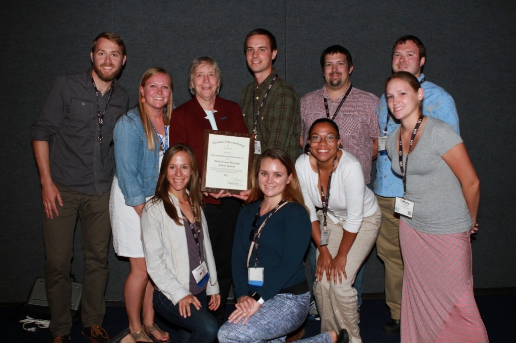 AFS Past-President Donna Parrish presents NCSU SFS members with the award for “Outstanding Student Subunit” at the 2015 Annual Meeting of The American Fisheries Society. (Pictured, left-to-right: Gus Engman, Casey Grieshaber, Caitlyn Bradley, Donna Parrish, Dylan Owensby, Mary Henson, Jared Flowers, Crystal Lee Pow, Tomas Ivasauskas, Tiffany Penland). Photo Credit: AFS, Rich Grost