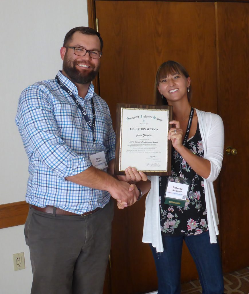 Jesse receives the Young Professionals Travel Award from Committee Chair Rebecca Krogman at the Education Section Business Meeting.